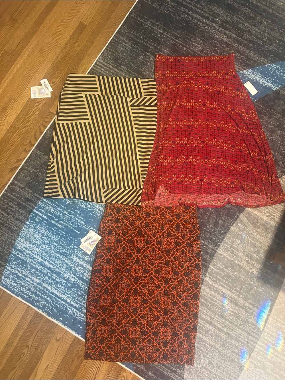 Bundle of three LuLaRoe Mixed-Print Skirt Trio in Red, Black, Tan